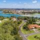 360 degree virtual tour USA aerial view of residential neighborhood with waterfront landscape, houses, roads, and scenic river surroundings