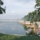 USA lakeside cottage 3D rendering with wooden cabins, calm lake view, boat dock, and lush green forest surroundings